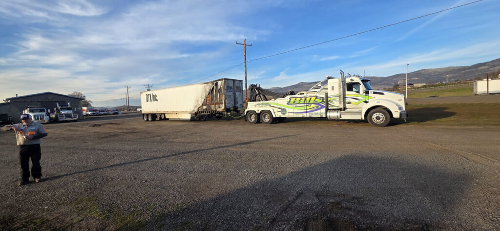 Bill's Towing recovering damaged semi trailer